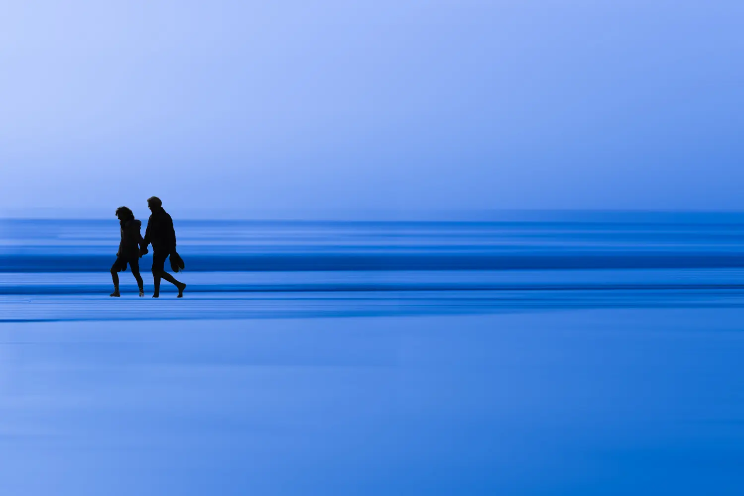 Photographie d'art bord de mer - Promenade couple sur la plage